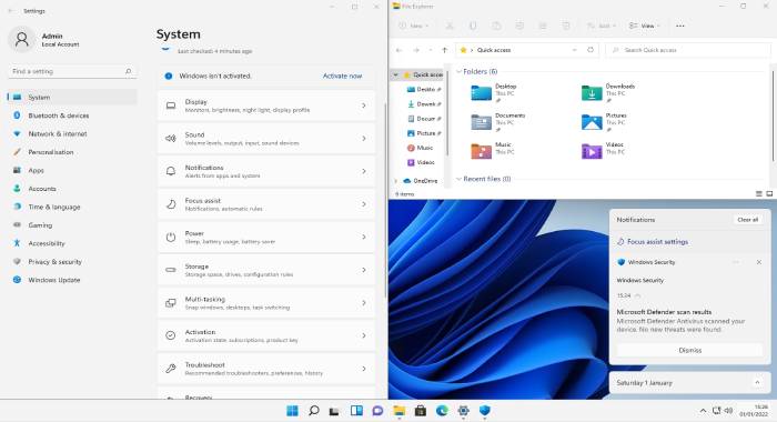 windows 11 desktop with settings, file explorer and notifications in snapped layout